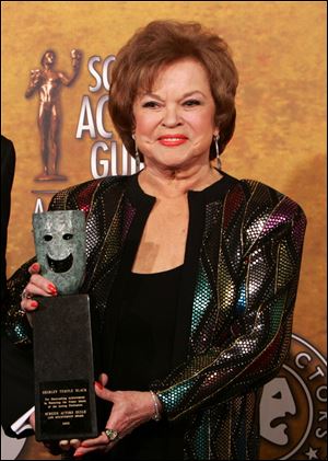 Shirley Temple Black poses with the Screen Actors Guild Awards 42st annual life achievement award at the 12th Annual Screen Actors Guild Awards, in Los Angeles in January, 2006.
