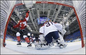 Meghan Agosta-Marciano of Canada celebrates her second goal of the game against USA Goalkeeper Jessie Vetter during the third period in Sochi, Russia. Canada won 3-2 over the United States. 