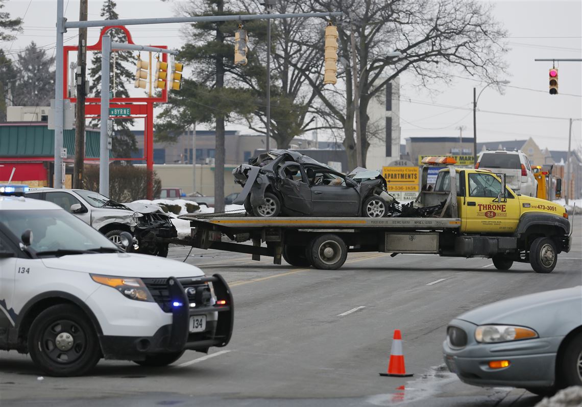 Cars are hauled away from the intersection of Dorr and Byrne streets.