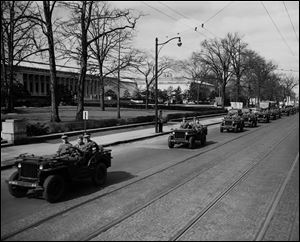 A convoy, escorted by military police, delivers the paintings to the Toledo Museum of Art in 1949 on the last stop of a U.S. tour. The museum’s assistant director was among the 345 Monuments Men.