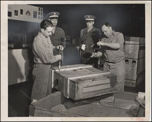 Crates are opened up under Army supervision. The paintings came from other cities in padded and heated railcars and then by truck.