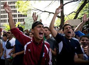 Students shout slogans against Venezuela's President Nicolas Maduro during a march to Venezuelan Telecommunications Regulator Office or CONATEL in Caracas, Venezuela, Monday.
