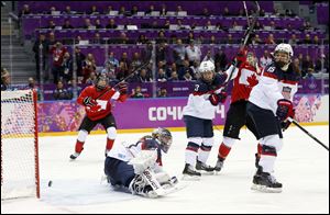 Team Canada reacts after scoring the winning goal in overtime over the USA to win the women's gold medal ice hockey game Thursday in Sochi, Russia.