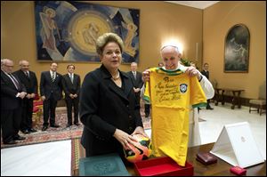 Pope Francis exchanges gifts with Brazilian President Dilma Rousseff during their audience Friday at the Vatican.