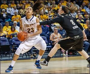 SPT utwomen24p    WMU's #3, Julia Henson reaches in on UT's Inma Zanoguera.  The University of Toledo's women's basketball team (13-11, 8-5 MAC) hosts Western Michigan University (10-14, 6-7 MAC) in Toledo, Ohio on February 23, 2014.   The Blade/Jetta Fraser