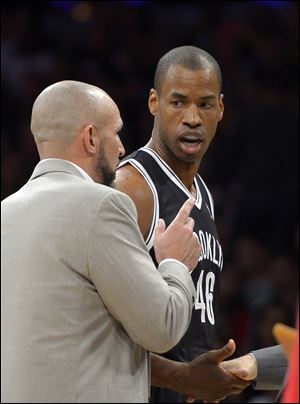 Brooklyn Nets center Jason Collins, right, talks with head coach Jason Kidd during the second half on Sunday in Los Angeles.