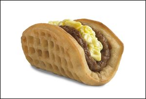 Taco Bell says the waffle taco includes scrambled eggs, sausage and a side of syrup.