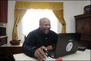 Ernest Morgan holds a computer video chat with a friend, while at home, in San Francisco. Morgan was released from San Quentin State Prison in 2011 after serving 24 years for the shotgun slaying of his stepsister as he burglarized his parents' home. 