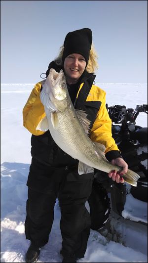 Tammy Irby from Petersburg, Mich., caught this 30-inch walleye which weighed almost 12 pounds on a recent ice fishing outing on Lake Erie.