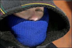 April Sumner, originally from Florida, bundles-up so much that only her nose and eyes are visible under her coat and hat during record cold temperatures on Feb. 12.
