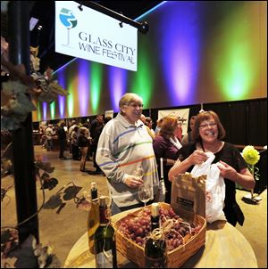 Rob and Kathy Pawloski of Toledo sample wine from some of the 14 wineries from Ohio at the second — and sold-out  — Glass City Wine Festival at the SeaGate Centre downtown. 
