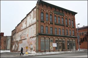The Black Cloister Brewing Co. CEO plans to open his brewery at  619 Monroe St. in downtown Toledo, at left.