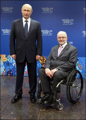 Russian President Vladimir Putin, left, and International Paralympic Committee President Philip Craven pose at a meeting with International Paralympic Committee board members and honorary council members before the opening ceremony of the 2014 Winter Paralympics.