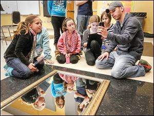 Amelia Niedermier, left, is one of several students being taught by Eric Shanteau, right, how to use mirrors for extra creativity during Shorties U, hosted by the Sylvania Community Arts Commission.