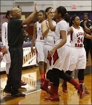 Rogers coach Lamar Smith high-fives Keasja Peace in the City League championship game. Smith has a record of 84-19 with the Rams.