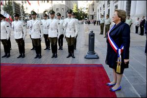 Chile's new President Michelle Bachelet reviews the troops as she arrives to Moneda presidential palace in Santiago, Chile.