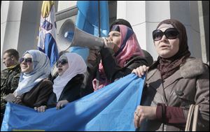 Pro-Ukrainian Crimean tartars protest against the Russian invasion in to the Ukrainian territory in front of  Ukrainian parliament building in Kiev, Ukraine Tuesday.