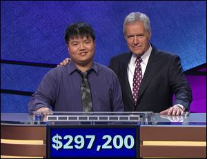 ‘Jeopardy!’ host Alex Trebek with contestant Arthur Chu with a display of the former champion’s winning on the show.
