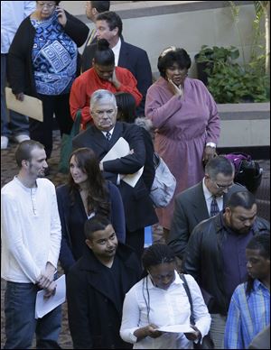 Job seekers line up to meet prospective employers at a career fair at a hotel in Dallas.