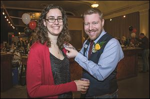 Jess Buetikofer gets a corsage pinned on by her husband Eric during the American Red Cross of Wood County’s Fire & Ice event.