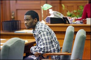 Defendant Quincy Allen listens to testimony during the opening day of his trial in Lucas County Common Pleas Court. Allen was found guilty of muder with firearm and gang specifications.