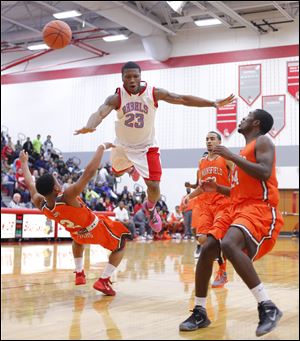 Bowsher High School player Nate Allen (23) is fouled by Mansfield Senior High School player DeJorr Gibson (2) during the fourth quarter.