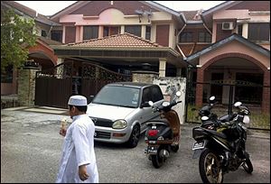 A Muslim boy leaves a mosque after Friday prayers, just down the road from the home of Fariq Abdul Hamid, co-pilot of the missing Malaysia Airlines jetliner MH370 in Shah Alam, Malaysia.