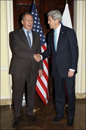 Russian Foreign Minister Sergey Lavrov, left, and U.S. Secretary of State John Kerry shake hands prior to a meeting at Winfield House in London today.