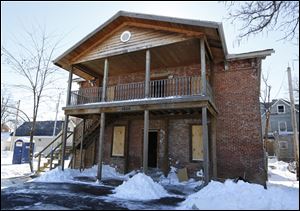An old carriage house at 1026 N. Huron St. is being renovated into two apartments by high school dropouts ages 18-24 who are learning a trade while studying to finish their education.