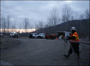 Officials work at the scene of a leak from a crude oil pipeline in Colerain Township, Ohio. 