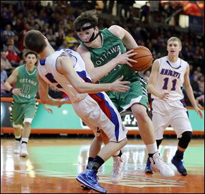 Ottawa Hills' Geoff Beans (3) charges over Convoy Crestview's Cam Eltzer (5) during the Division IV boys regional basketball semifinal.