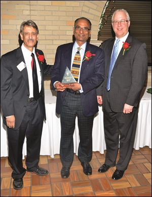 Dr. Agha Shahid, Dr. Shirish Shah receiving an award for 35 years of service, Alan Sattler.