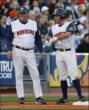 Mud Hens manager Larry Parrish is all smiles as Michael Bertram reaches third base after a triple in a 2010 game.