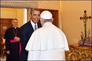 Pope Francis welcomes President Obama as Archbishop George Gaenswein, background left, looks on, at the Vatican today.