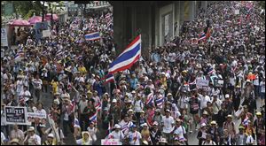 Tens of thousands of anti-government protesters marched through the streets of the Thai capital Saturday, reviving their whistle-blowing, traffic-blocking campaign to force the resignation of the prime minister Yingluck Shinawatra.
