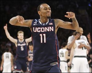 Connecticut's Ryan Boatright celebrates after his team defeated Michigan State 60-54 in a regional final Sunday in New York.