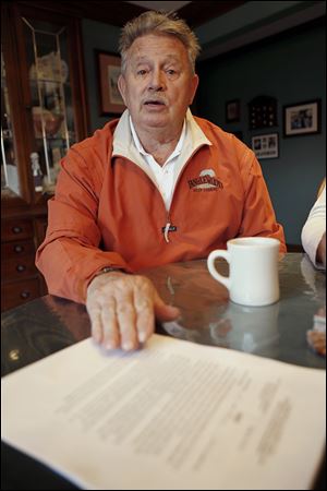 Bruce Clingan, who owns the Tanglewood Golf Course, poses for a photo with a lease he signed with gas drilling company Hilcorp in his home in Pulaski, Pa. Clingan is one of a group of property owners in the area that signed a lease that is hoping to start collecting royalty checks from the gas under their land. 