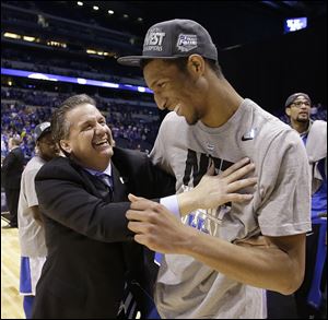 Kentucky coach John Calipari celebrates with Marcus Lee after the Wildcats’ win.