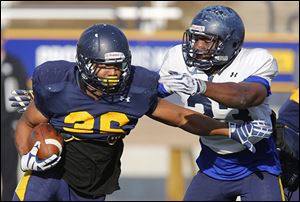 University of Toledo’s Ricky Pringle, left, tries to get past Junior Sylvestre during practice at the Glass Bowl.