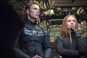 This image released by Marvel shows Chris Evans, left, and Scarlett Johansson in a scene from 