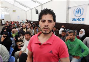 Syrian refugee Yahya, speaks to journalists at the United Nations High Commissioner for Refugees registration center today in the northern city of Tripoli, Lebanon.