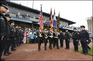 The Toledo Firefighter honor guard presents the colors during the Mud Hens season opener against Louisville on Friday at Fifth Third Field.