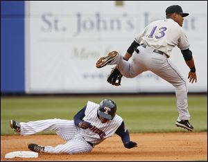 Louisville’s Argenis Diaz starts a double play by getting out the Mud Hens’ Ezequiel Carrera in the first inning on Friday.