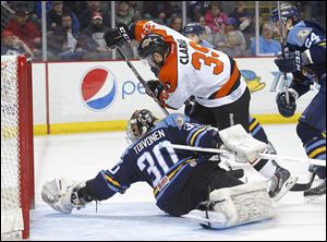 Walleye goalie Hannu Toivonen makes the save against Fort Wayne’s Aaron Clarke during the second period. Clarke scored against his former team in the win.