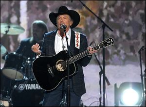 George Strait performs t the 49th annual Academy of Country Music Awards at the MGM Grand Garden Arena on Sunday in Las Vegas. Strait won his second entertainer of the year — 25 years after he won his first — on Sunday.
