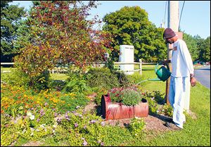 Mike Davis waters some plants at Bittersweet Farms.