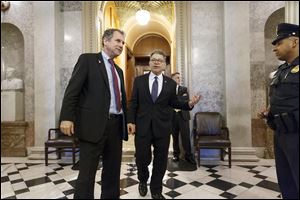 Sen. Sherrod Brown, D-Ohio, left, and Sen. Al Franken, D-Minn., leave the chamber during the vote on restoring jobless benefits today at the Capitol in Washington.