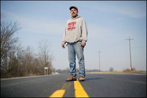 Matt Coger, in the middle of old U.S. 24 near Texas, Ohio, says the old route is now like a ‘country road.’