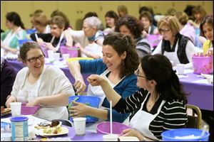 Shannon Holleran of Maumee, Stephanie Shaulskiy of Sylvania, and Lauran Sachs of Sylvania Township laugh during a Passover baking class March 19 at Etz Chayim in West Toledo. About 50 women attended the class, taught by author Paula Shoyer..