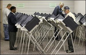 Voters in Toledo cast ballots at an early-voting site operated by the Lucas County Board of Elections. 